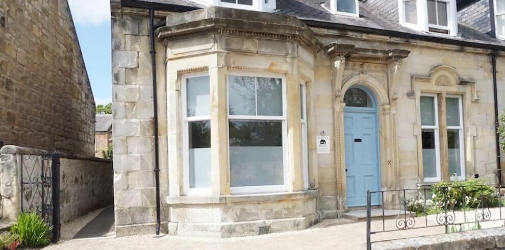 Sandstone villa with blue door