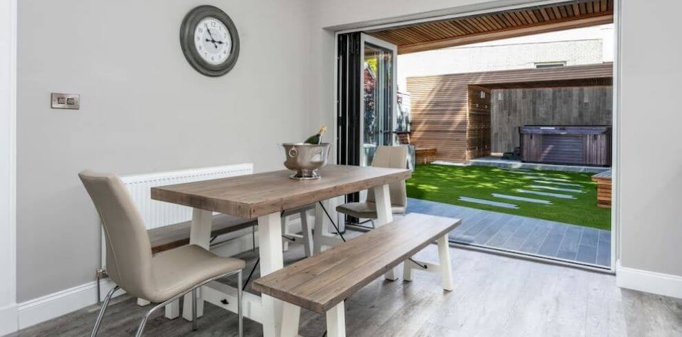 Dining area with bi fold doors opening ton to garden