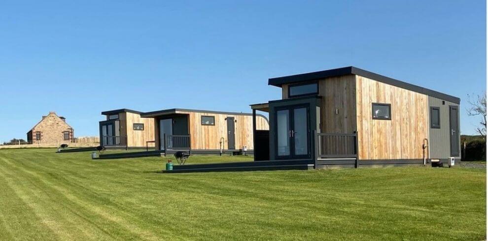 Large glamping pods on a field