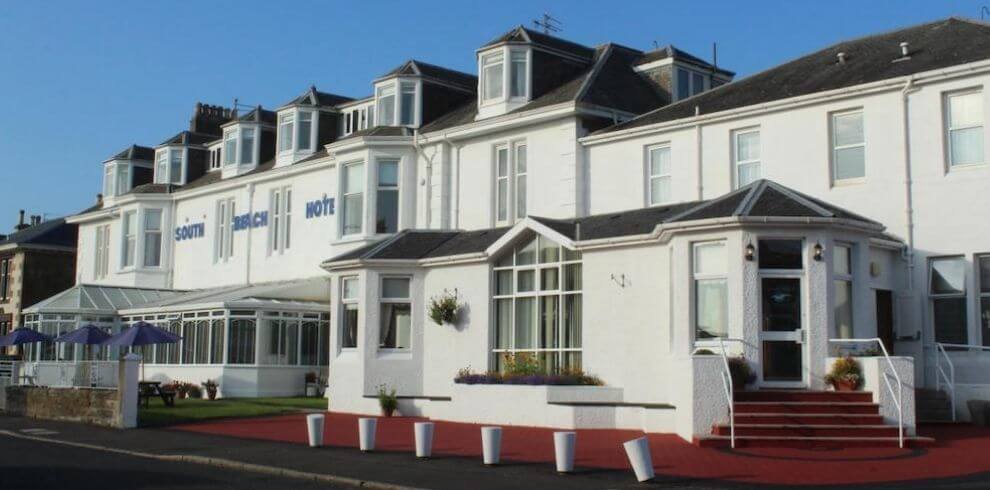 White victorian building with a conservatory