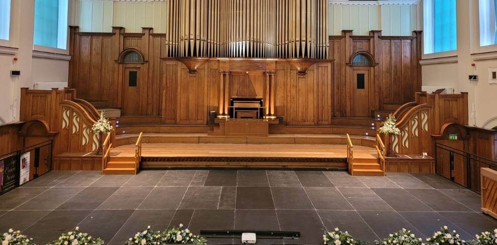 The town hall set up for a wedding with tables and seating.