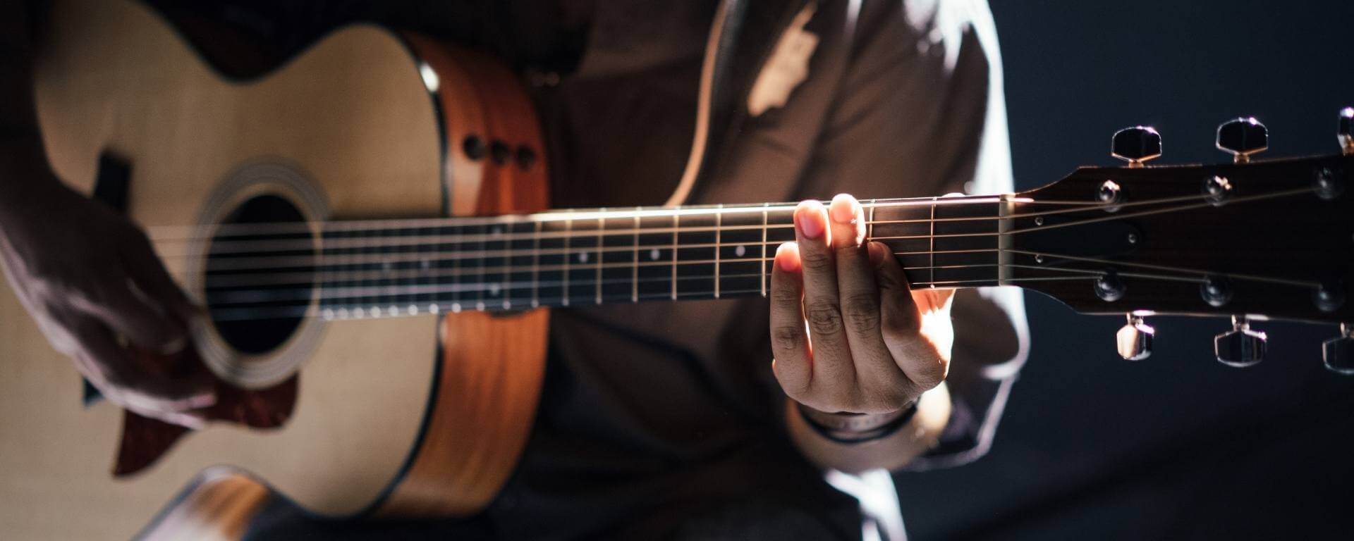 Man playing an acoustic guitar.