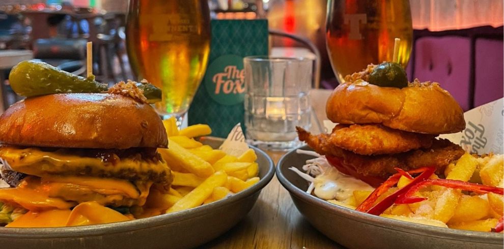 Up close view of delicious looking burgers and chips.