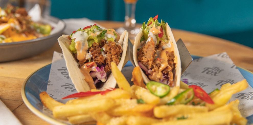 Plate of loaded tacos and chips.