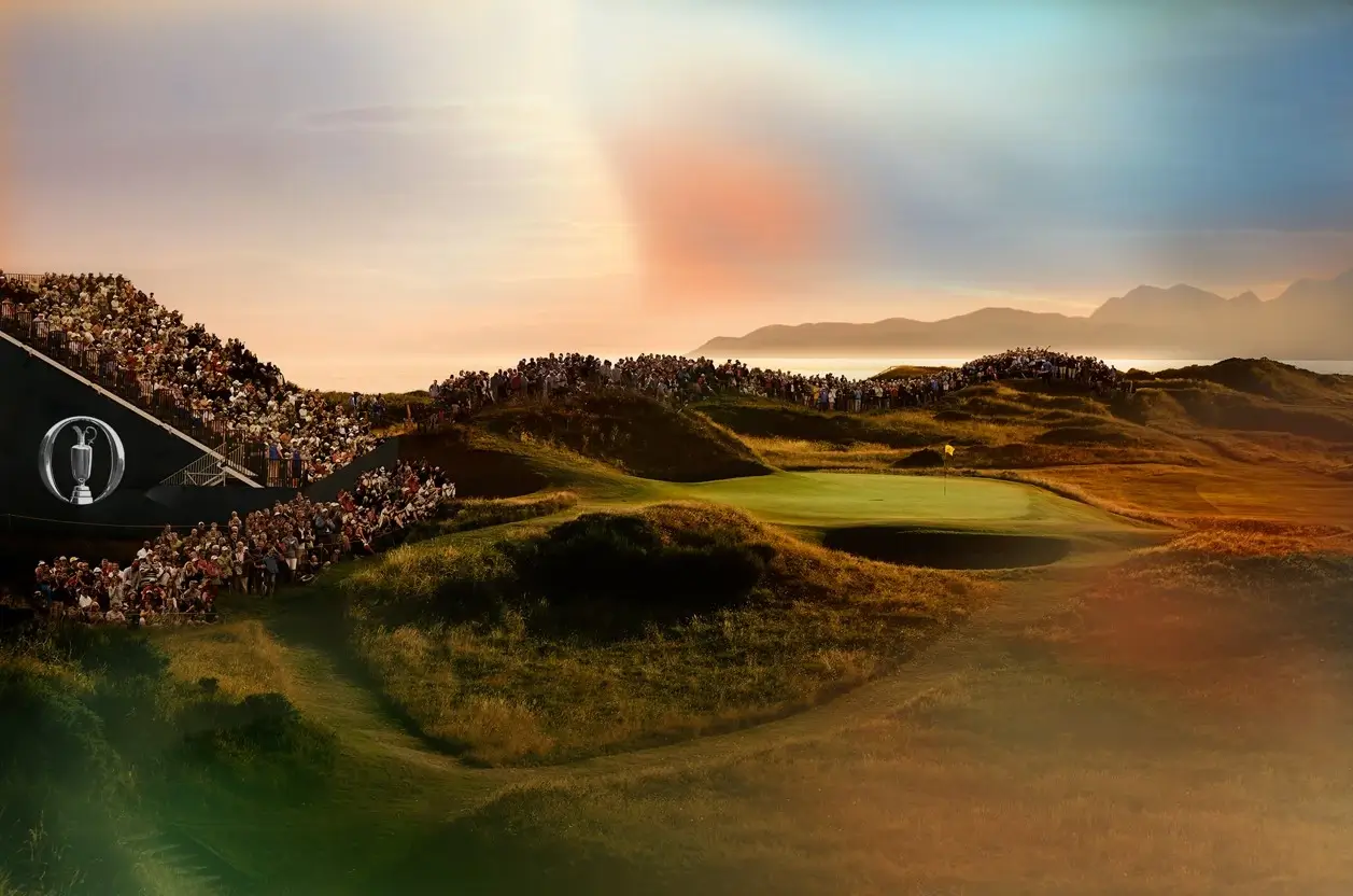 Golf course with setting sun and sea in the distance.