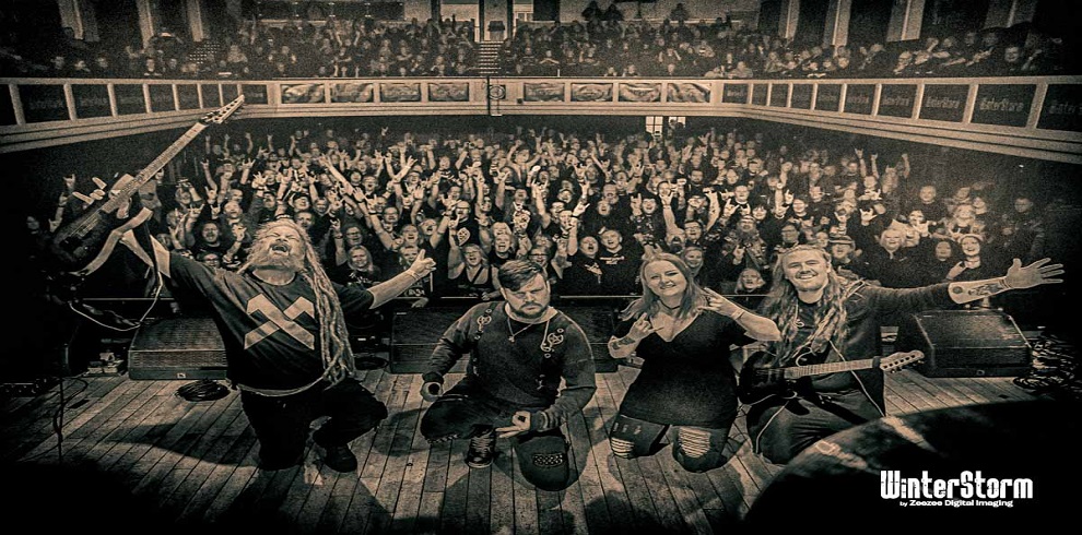 WinterStorm on stage at Troon Concert Hall with the audience in the background.