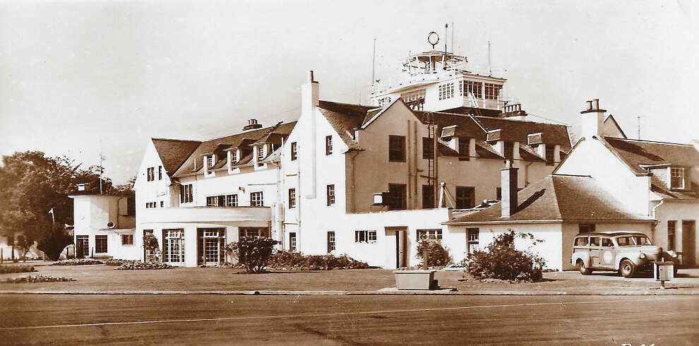 An old black and white photograph depicts an airport control tower.