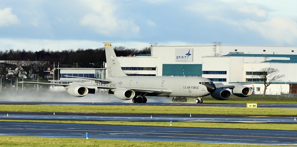 A picture of an US Air Force plane on the tarmac with the Spirit AeroSystems in the background.