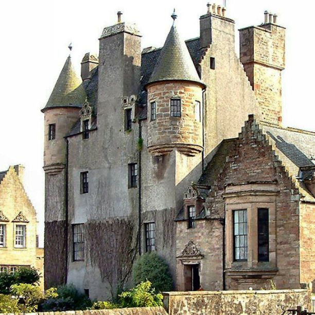 A historic castle with turrets and small windows
