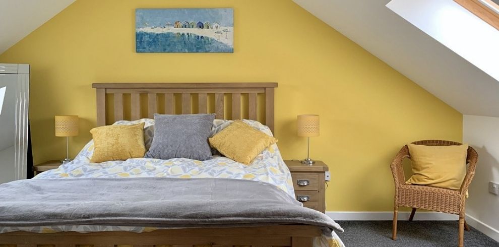 Bright bedroom with a yellow wall