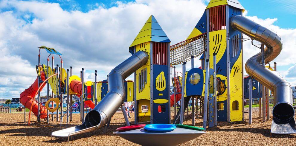 Brightly coloured play park with slides.