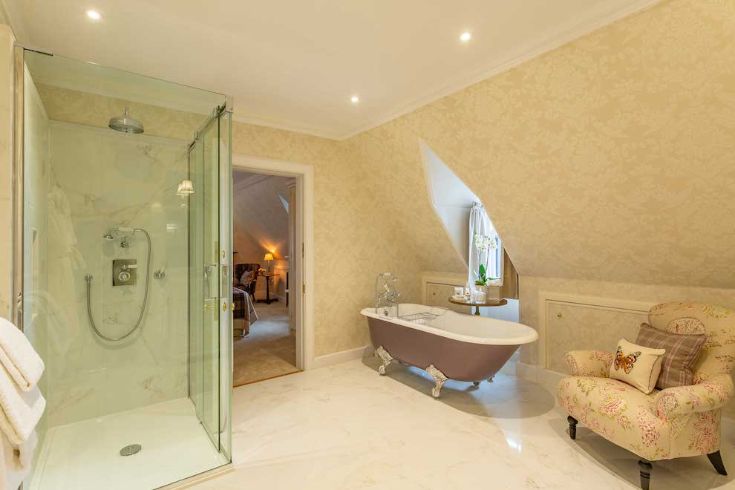 bathroom with roll top bath and walk in shower