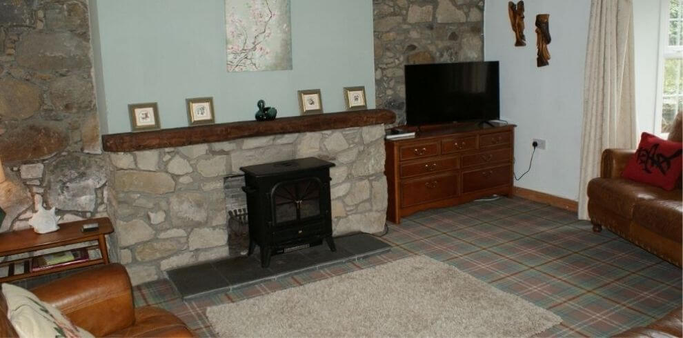 stone fireplace in lounge with a television