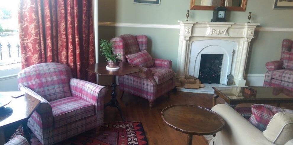 wingback chairs in a cosy room with fire