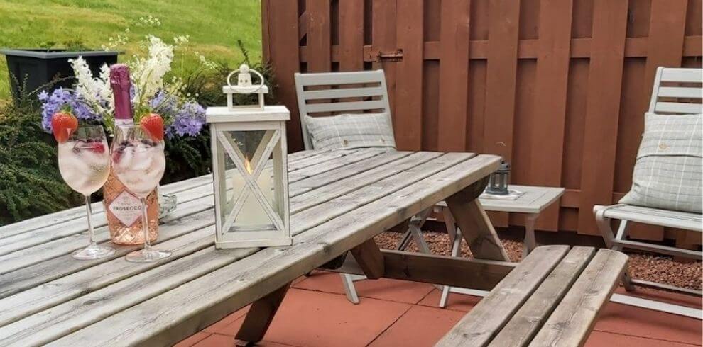 Picnic table in the garden with a lantern