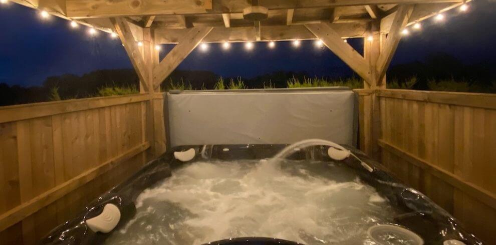 Covered hot tub with jets and fairy lights