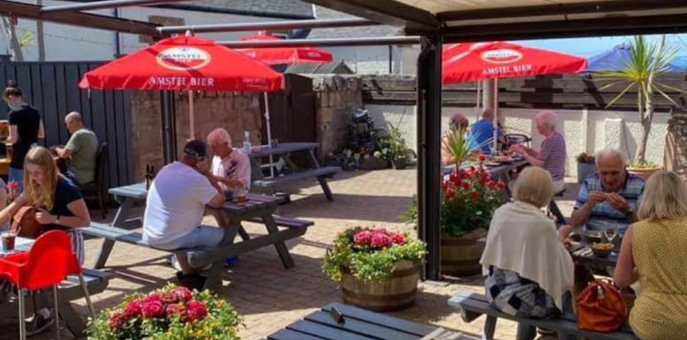 Beer garden with tables and parasols