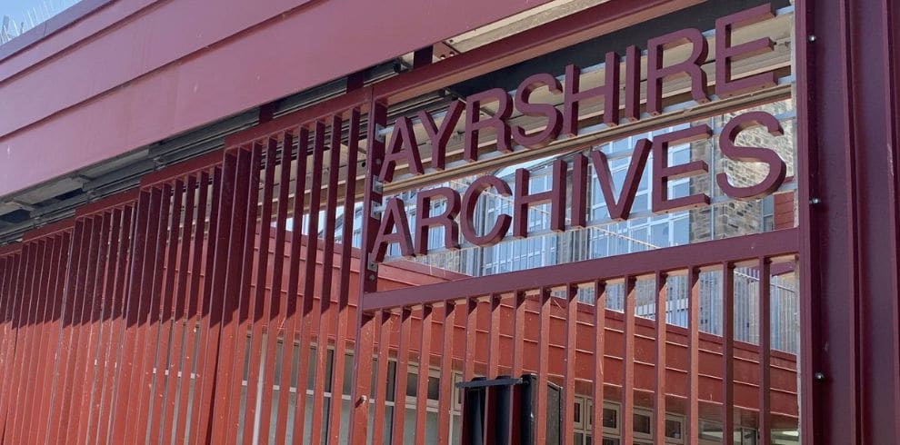 red metal railings with Ayrshire Archives sign