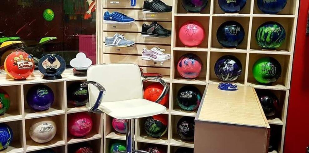 Bowling balls and shoes on display