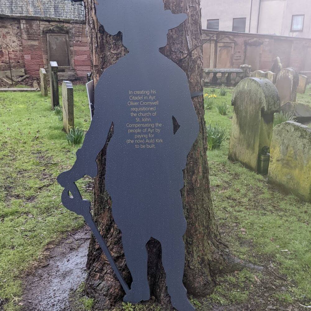 Wooden silhouette of Oliver Cromwell against a tree.