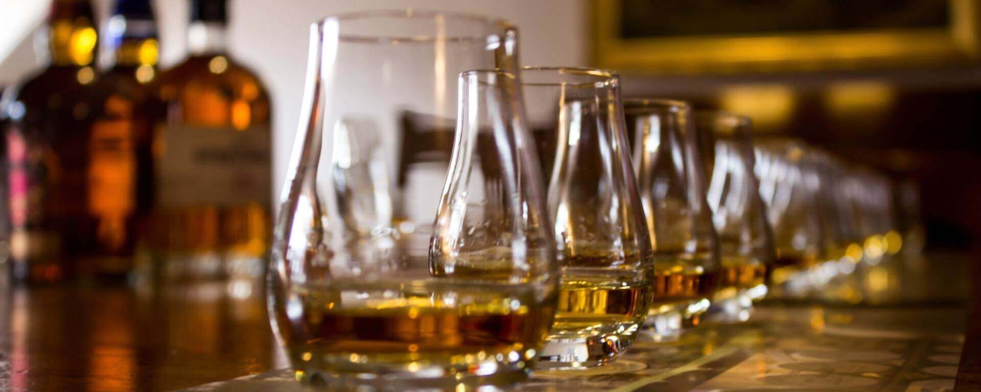 Whisky glasses and bottles set for tasting.