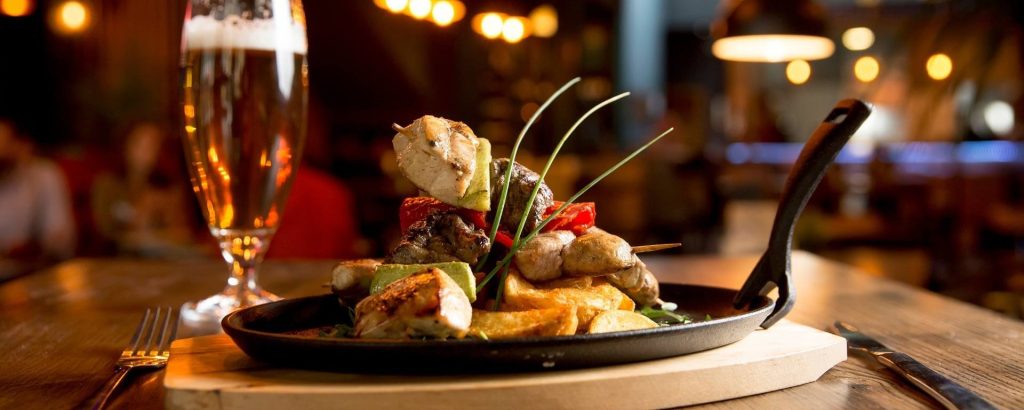 Plate of delicious food and a glass of beer.