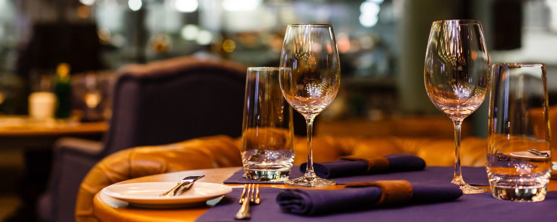 Restaurant table set with wine glass.