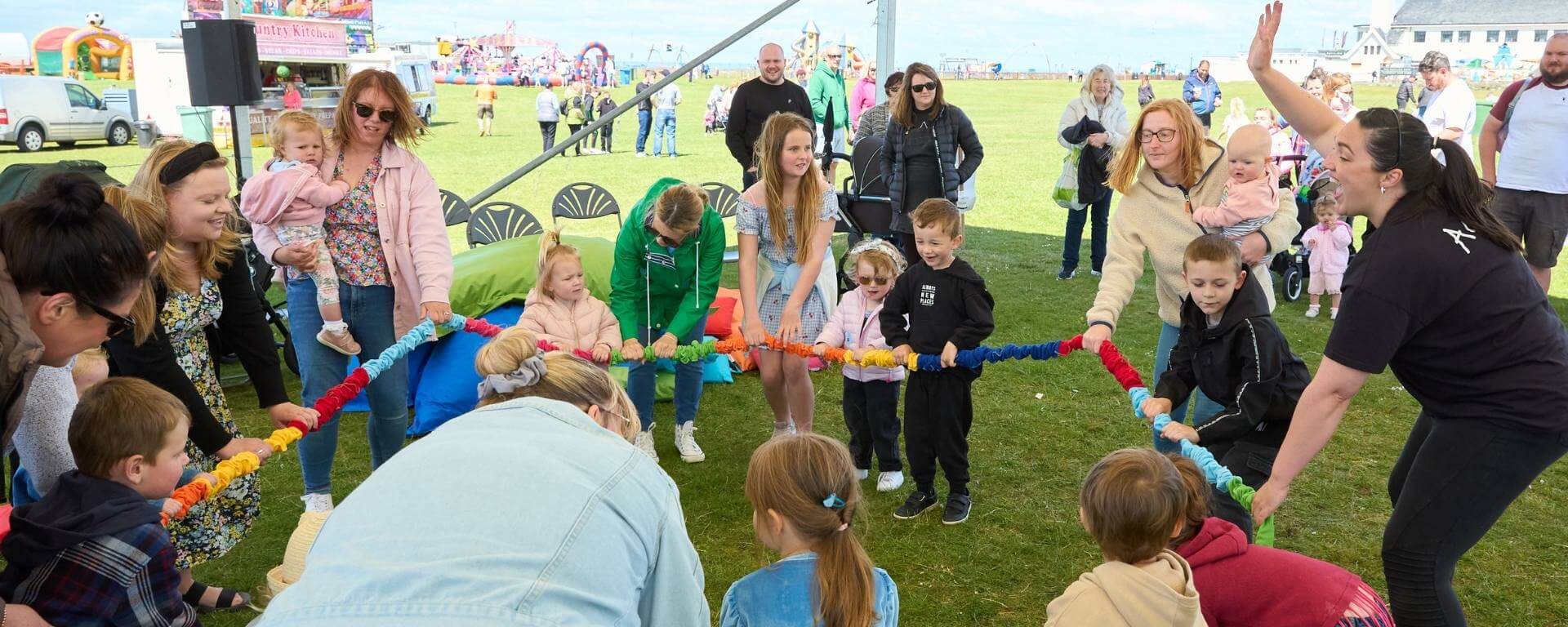 Parents and young children at an outdoor event.