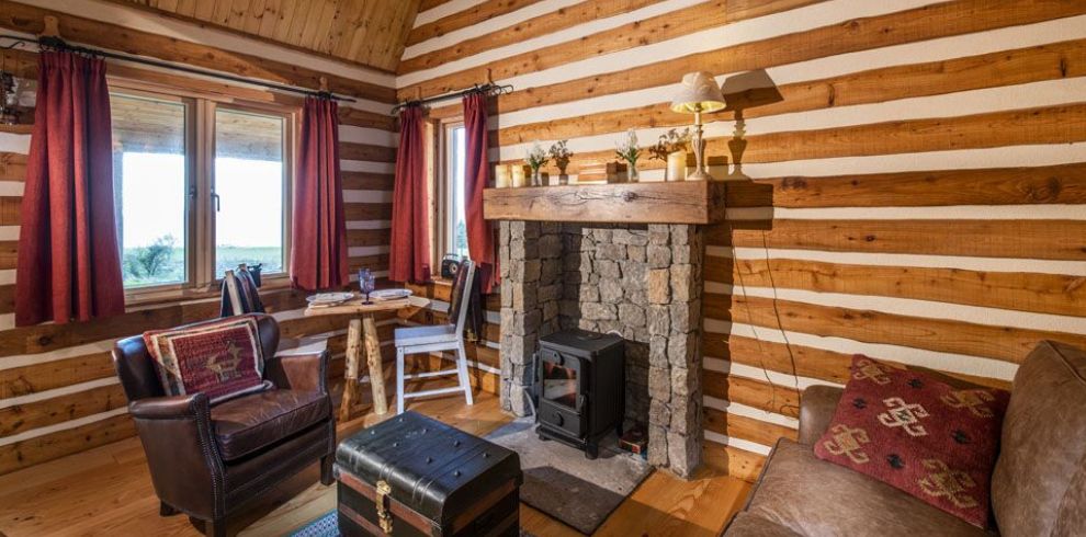 Cabins looking at Fireplace in the living room with a coach and a chair
