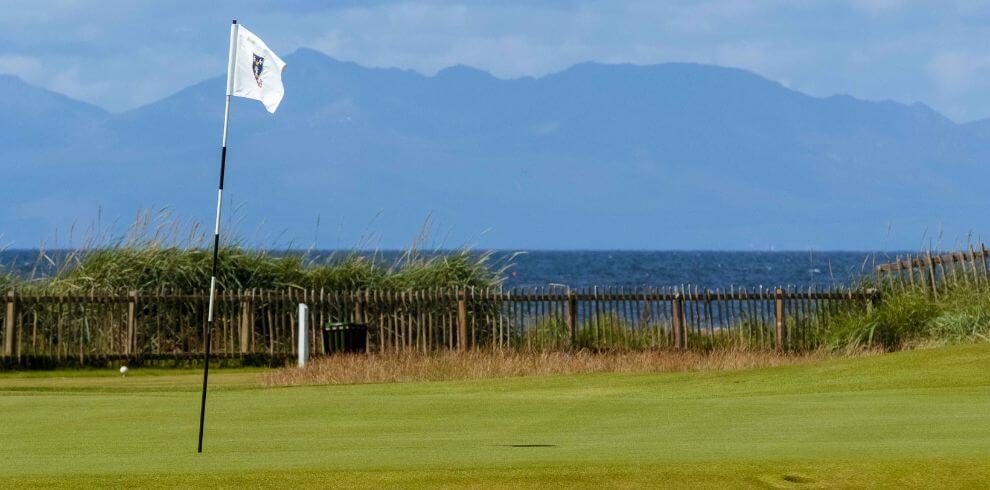 Golf course hole, with a view of the hills of Arran in the distance.