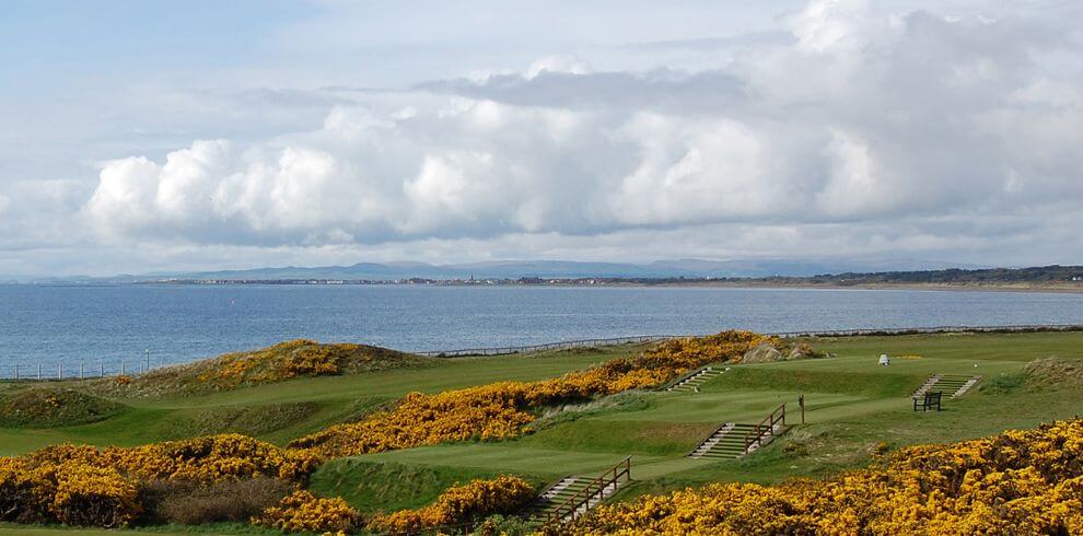 A photograph of Prestwick St Nicholas Golf Club. Features include the fairway with a view of the Firth of Clyde in the background.