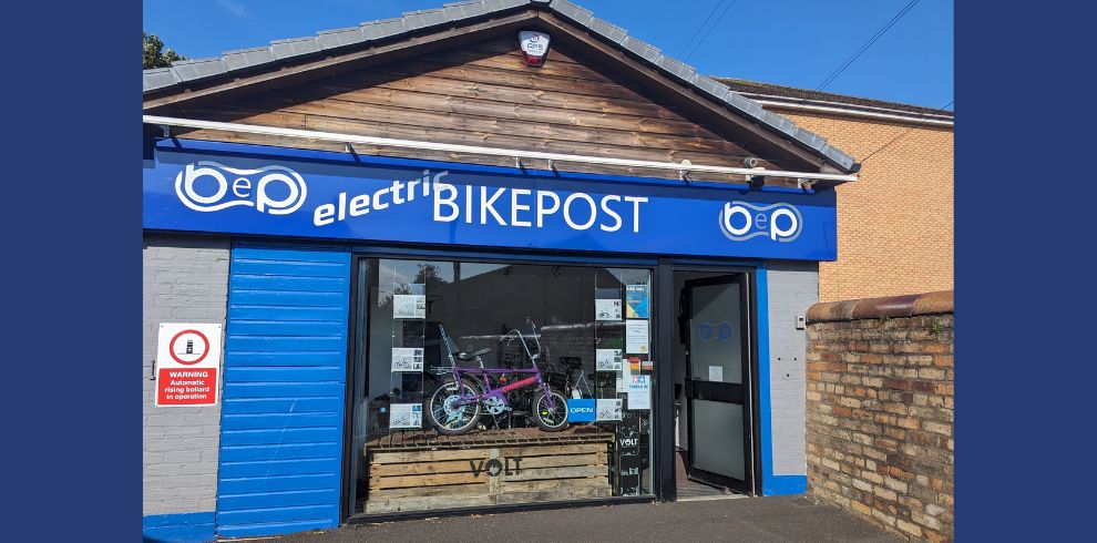 Photographic image of an electric bike shop called "Electric Bikepost" on a sunny day.
