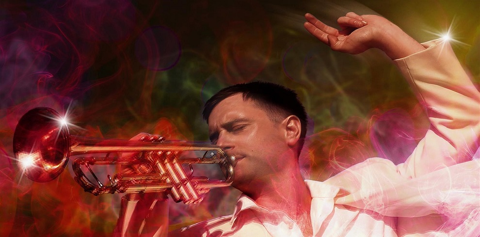 An image of a man playing a trumpet.