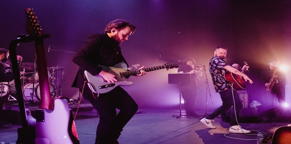 A picture of Blue Rose Code performing on stage.