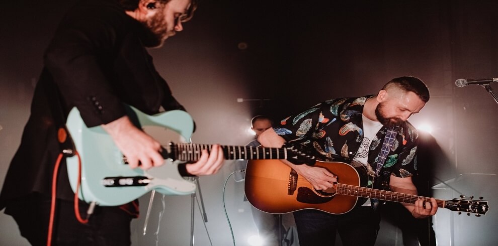 A picture of Blue Rose Code performing on stage.
