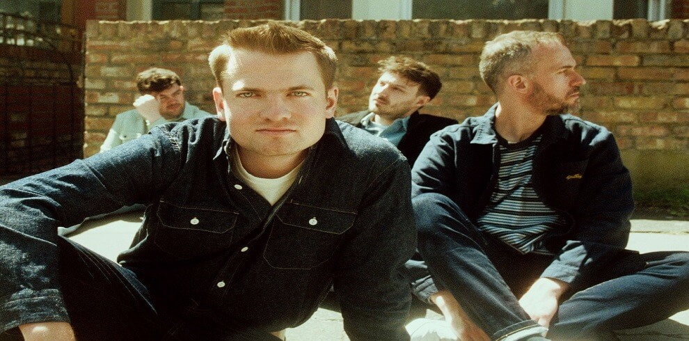 A picture of Tide Lines sitting outside in front of a brick wall.