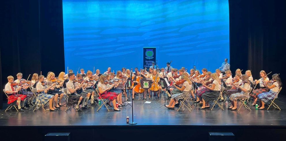 An image of an orchestra on stage performing.