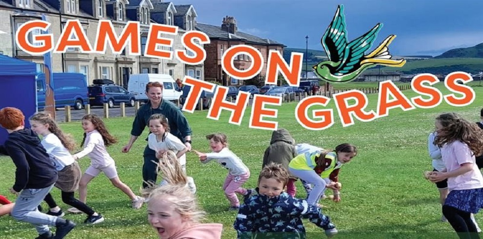 A picture of children having fun outside on the grass.