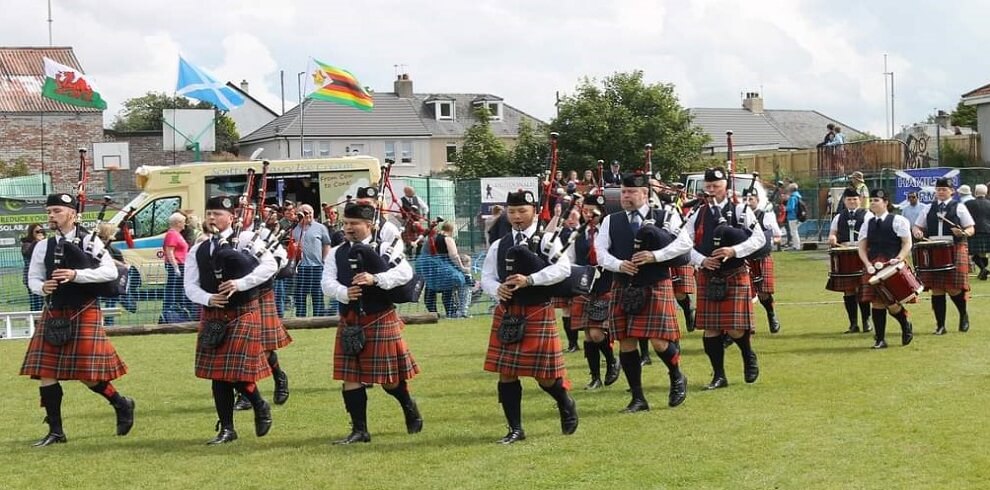 A picture of a pipe band with kilts performing at Dundonald Highland Games.