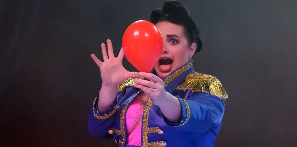 A picture of a femal holding a red balloon.