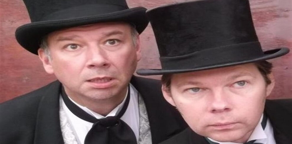 A picture of Holmes and Watson looking puzzled. They are both wearing top hats and cravats.