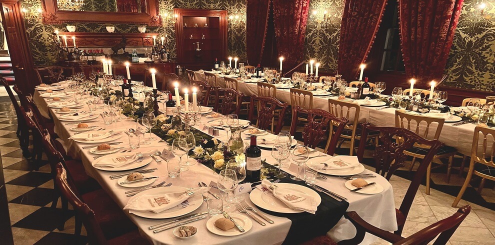 A picture of an opulent dining room with the tables set.