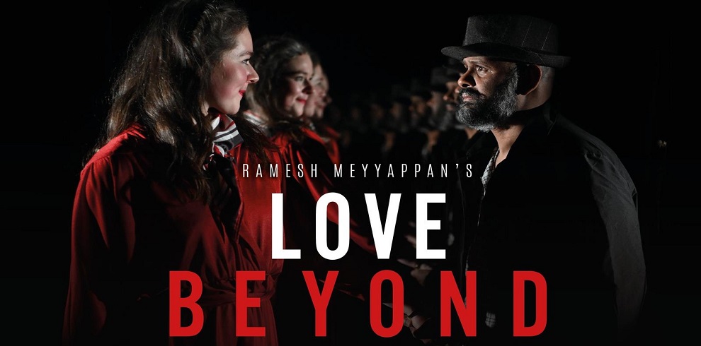 The image features a black background with a male and a female cast member from the play "Love Beyond" by Ramesh Meyyappan. They are gazing into each other's eyes, conveying a deep emotional connection. In the center of the image, the text "Love Beyond" is prominently displayed, highlighting the title of the play. The overall mood is intimate and focused, emphasizing the theme of the performance.