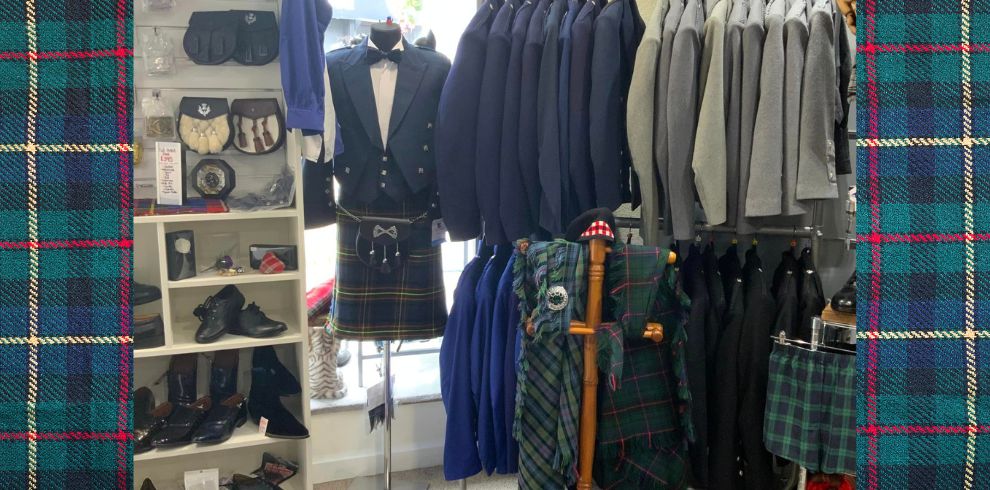 A picture of a rail of kilts and blazers.