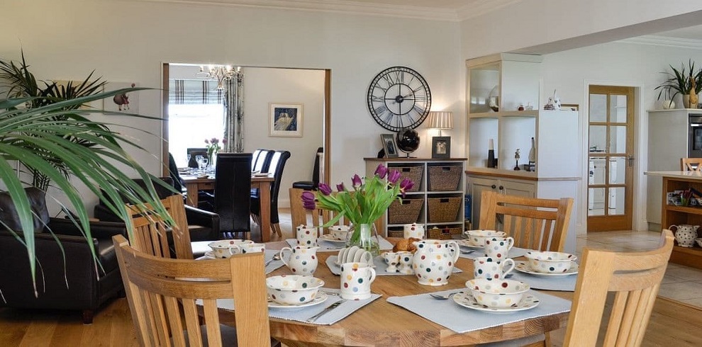 Area showing china set up at a table, inviting for breakfast.