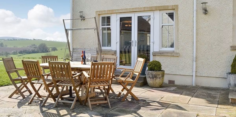 The outside of Yonderton House with garden furniture.