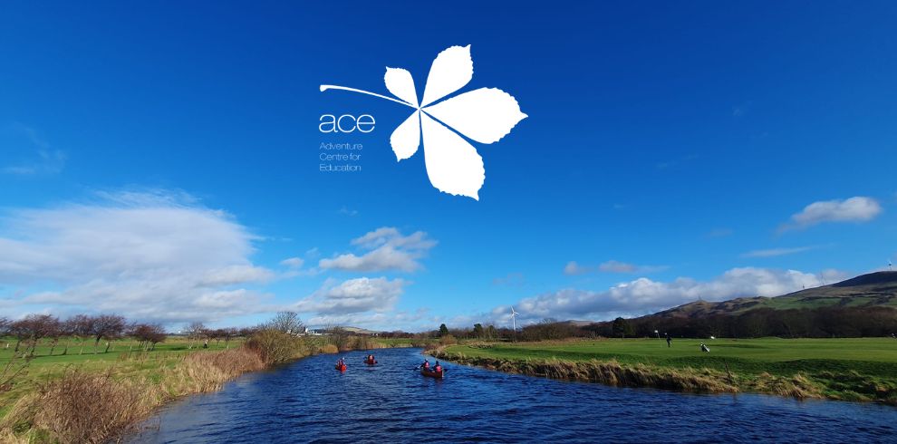 People canoeing along a river on a lovely day.