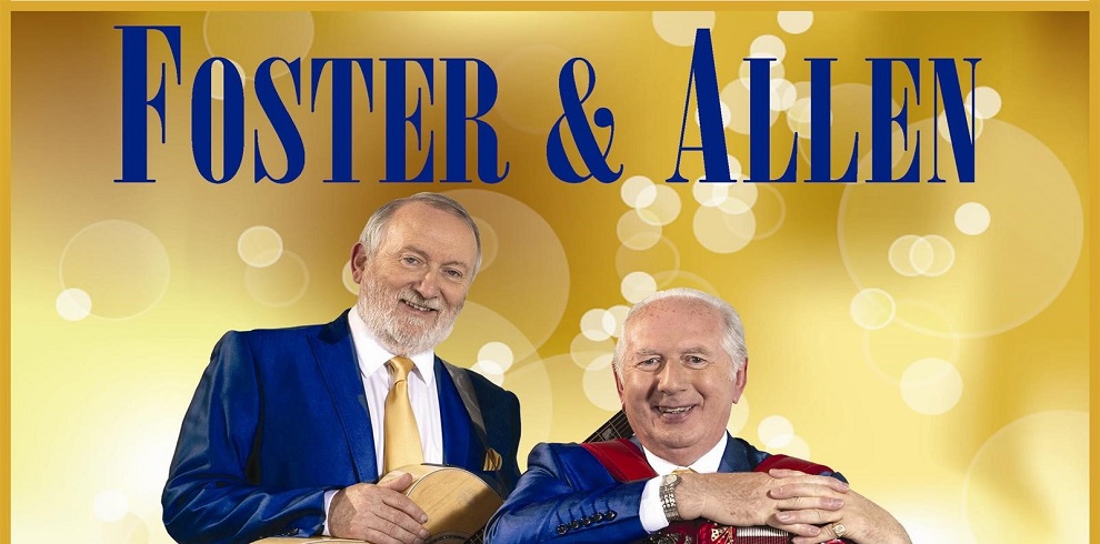 A picture of Foster & Allen smiling. The background shows gold bubbles and the title Foster & Allen in blue writing.