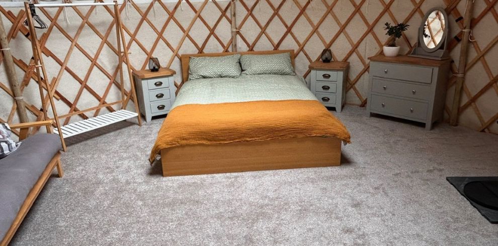 The interior bedroomof a glamping yurt.