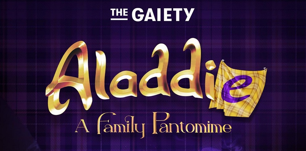 The image shows a promotional poster for a theatrical pantomime production titled "Aladdie," presented by "The Gaiety." The title is written in bold, golden lettering with a whimsical font, and the letter "e" at the end of "Aladdie" is highlighted with a tartan fabric pattern. Below the title, it reads "A Family Pantomime" in a smaller, elegant font. The background is a deep purple with a subtle tartan pattern, reinforcing the Scottish theme.